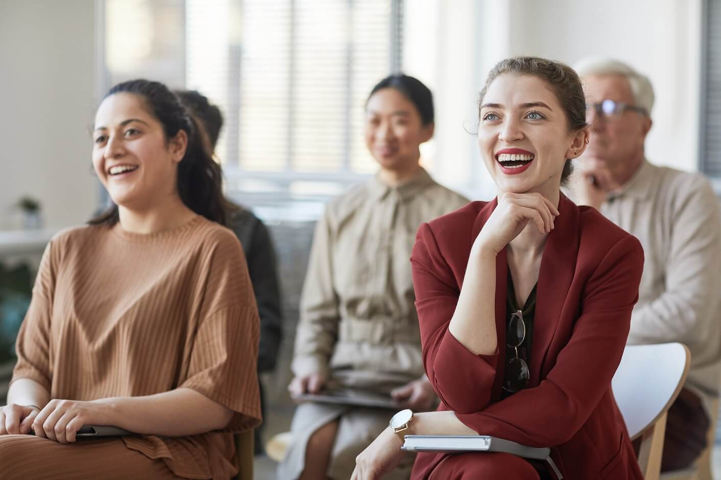 smiling-audience-listening-to-seminar-DHACKR3.jpg